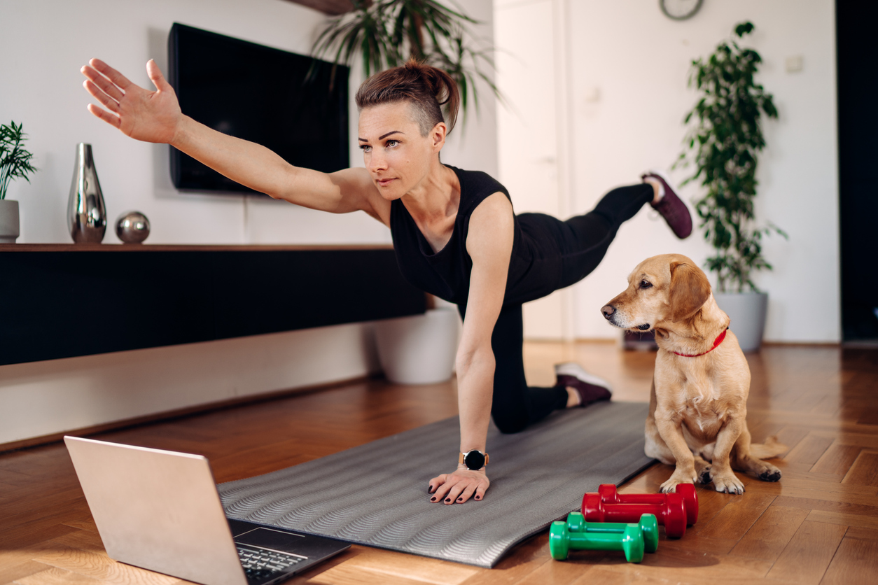woman doing virtual PT with her dog