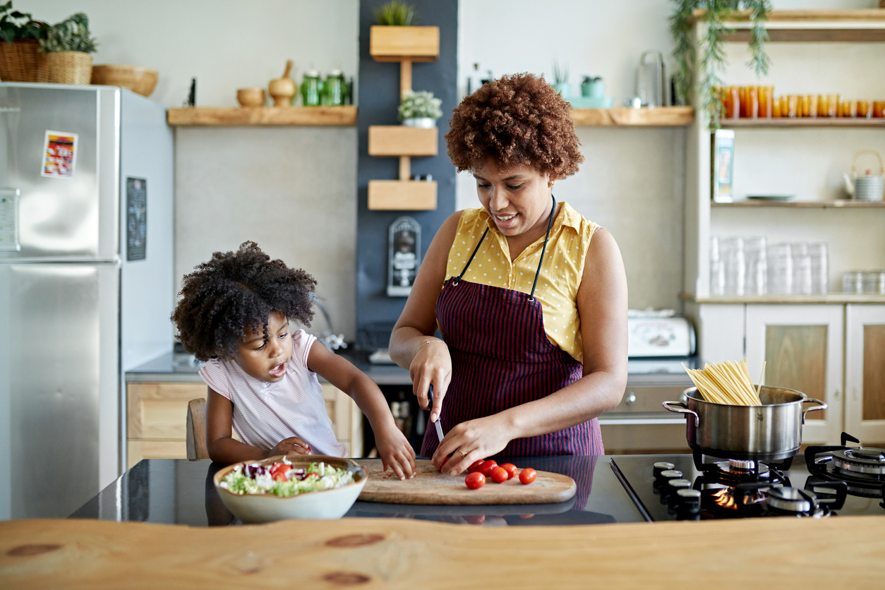Woman making food with her daughter